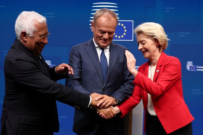 Polish Prime Minister Donald Tusk, European Council President Antonio Costa and European Commission President Ursula von der Leyen place their hands on top of each other following a press conference, on the day of the European Union leaders summit in Brussels, Belgium June 27, 2025. REUTERS/Yves Herman REFILE - CORRECTING DATE FROM