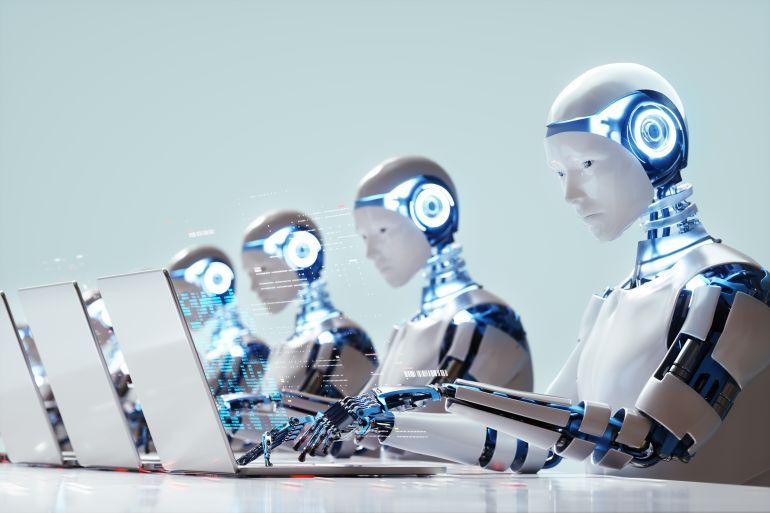 Digital generated image of multiple robots working on laptops siting in a raw. Smart technology, automation and artificial intelligence concept.