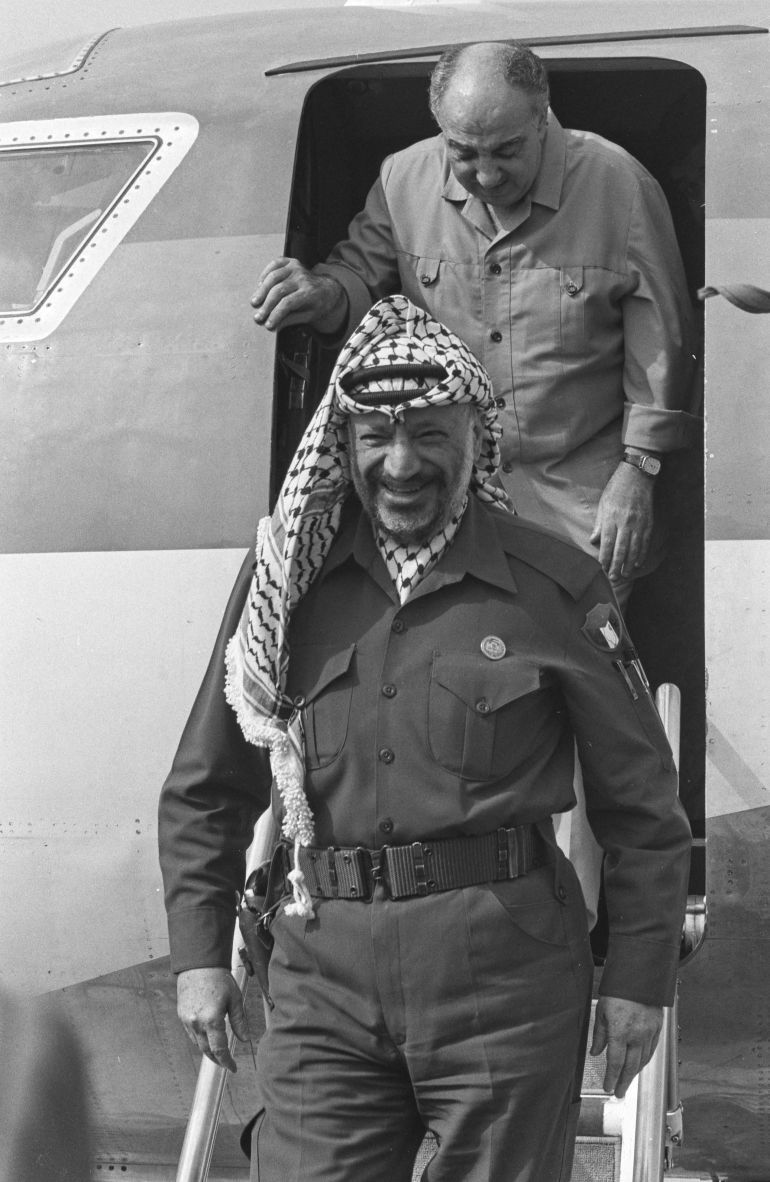 PLO leader Yasser Arafat followed by PLO member Salah Khalaf arrive at Cairo airport, where they will discuss faltering Israeli-Palestinian peace efforts with Egyptians. October 22, 1989 REUTERS/Cheryl Hatch 90117143
