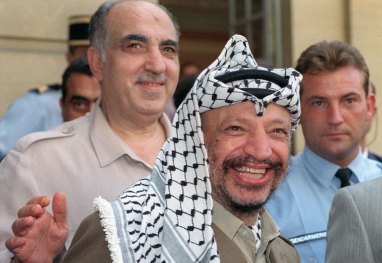 Palestine Liberation Organisation (PLO) chairman Yasser Arafat (C), surrounded by his advisers, including Salah Khalaf aka Abu Iyad (behind Arafat, smiling), addresses media 29 August 1990 in Paris after his meeting with French Premier Rocard. Abu Iyad, who was born to a middle-class family in Jaffa in 1933, was later put in charge of security and intelligence, including counter-intelligence, of PLO. Abu Iyad was assassinated in January 1991 by what PLO sources identified as a bodyguard of the PLO leader Abu al-Hawl, who was also assassinated that night. Reports suggested that the gunman belonged to Abu Nidal's organization, although the PLO has never investigated the assassination. AFP PHOTO PIERRE GUILLAUD (Photo by PIERRE GUILLAUD / AFP)