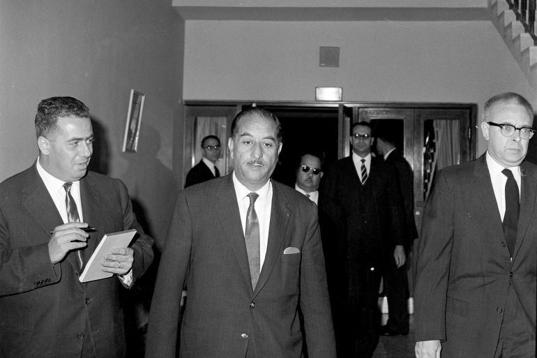 President Ahmed Hassan al-Bakr of Iraq, center, is shown in 1963, when he was the prime minister. According to a Baghdad radio report, a plot to overthrow President al-Bakr's government was smashed on Jan. 21, 1970. A special court tried and sentenced five accused plotters on Jan. 22. The radio report said they were sentenced and executed within the space of 2 1/2 hours. Exact date and location of the photo is unknown. (AP Photo)