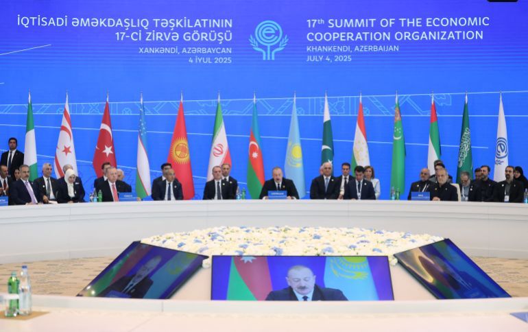 This handout photograph taken and released by the Turkish presidential press service on July 4, 2025, shows attendees, including Turkish President Recep Tayyip Erdogan, Azerbaijani President Ilham Aliyev and Iranian President Masoud Pezeshkian, taking part in the 17th Summit of the Economic Cooperation Organization in Khankendi, Azerbaijan.