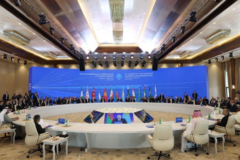 This handout photograph taken and released by the Turkish presidential press service on July 4, 2025, shows attendees, including Turkish President Recep Tayyip Erdogan, Azerbaijani President Ilham Aliyev and Iranian President Masoud Pezeshkian, taking part in the 17th Summit of the Economic Cooperation Organization in Khankendi, Azerbaijan.
