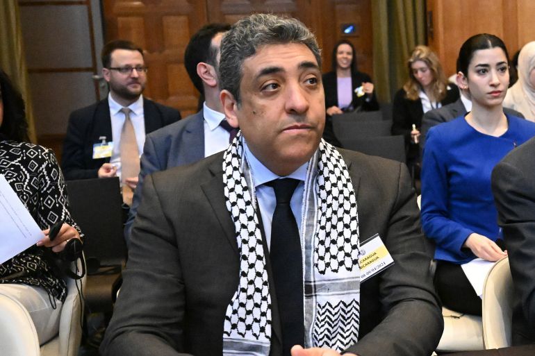THE HAGUE, NETHERLANDS - APRIL 09: Palestinian Deputy Foreign Minister for the United Nations (UN) and International Organizations Omar Awadallah (L) and Deputy Minister for Multilateral Affairs Ammar Hijazi (R) attend the hearing on Nicaragua's claim that Germany aids Israel's ongoing genocide in the besieged Gaza Strip at the International Court of Justice (ICJ) in The Hague, the Netherlands on April 08, 2024. The case concerns alleged violations of the Genocide Convention of 1948 and the Geneva Conventions of 1949 pertaining to international humanitarian law in Palestinian territories. (Photo by Dursun Aydemir/Anadolu via Getty Images)