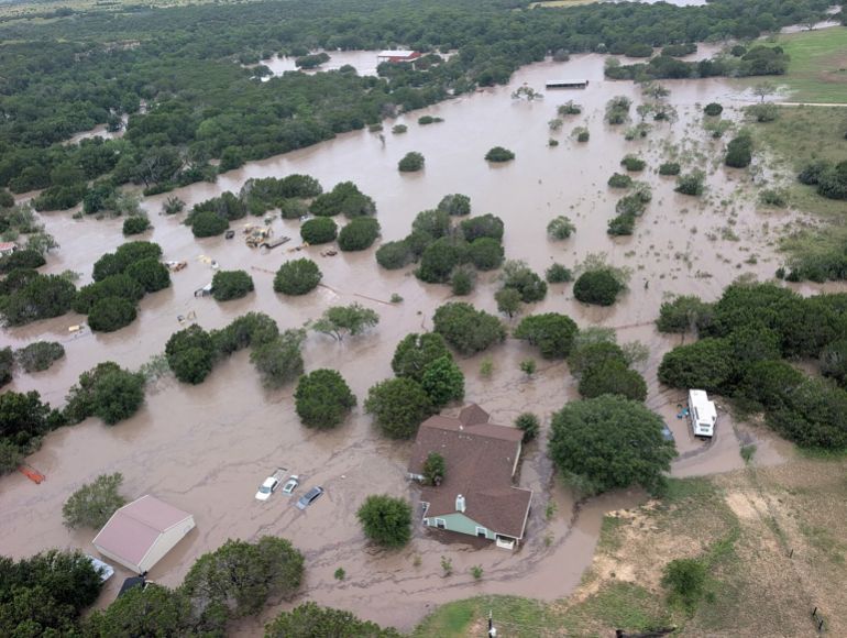 Houses and cars are partially submerged in flood waters in an aerial view near Kerrville, Texas, U.S. July 4, 2025. U.S. Coast Guard/Handout via REUTERS. THIS IMAGE HAS BEEN SUPPLIED BY A THIRD PARTY