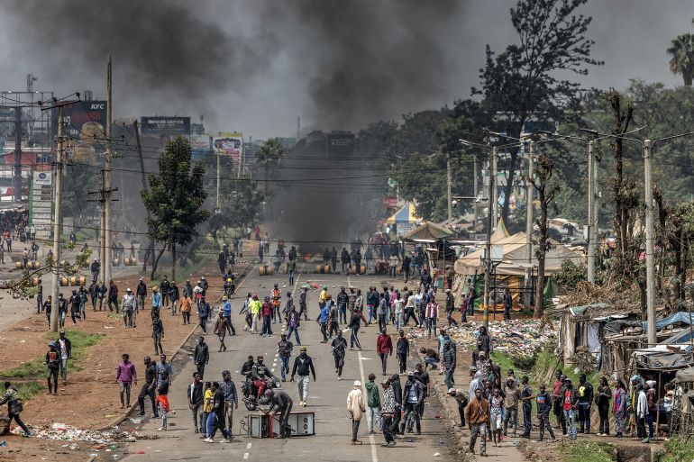 TOPSHOT - Protesters gather to block a main road with burning barricades and urban debris during clashes at Saba Saba Day demonstrations in Nairobi on July 7, 2025. Kenya marked its fight for democracy on July 7, 2025 with police blocking main roads in Nairobi ahead of potential protests, after last month's demonstrations descended into violent clashes. Saba Saba Day marks the uprising on July 7, 1990 when Kenyans demanded a return to multi-party democracy after years of autocratic rule by then-president Daniel arap Moi. (Photo by Luis TATO / AFP) Related content