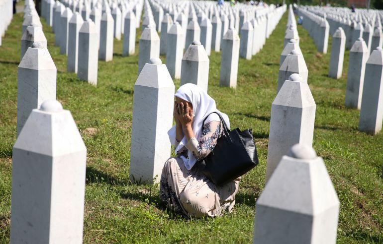A woman cries at a graveyard, ahead of a mass funeral in Potocari near Srebrenica, Bosnia and Herzegovina July 11, 2020. Bosnia marks the 25th anniversary of the massacre of more than 8,000 Bosnian Muslim men and boys, with many relatives unable to attend due to the coronavirus disease (COVID-19) outbreak. REUTERS/Dado Ruvic