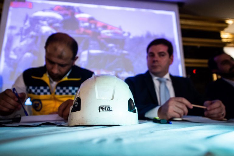 A helmet is seen next to Raed al-Saleh (L), head of the