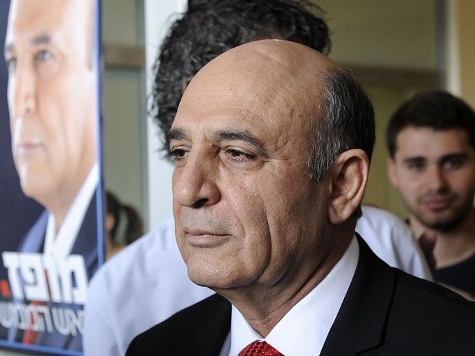 Shaul Mofaz, a senior Israeli politician and one of the candidates in the running in the elections for the leadership of the Kadima Party, stands next to one of his campaign posters in the city of Kfar Saba on March 27, 2012