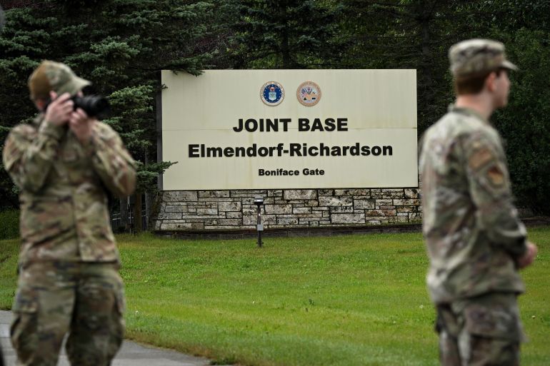 Members of the military stand outside an entrance to Joint Base Elmendorf-Richardson in Anchorage, Alaska, on August 14, 2025, ahead of the August 15 scheduled meeting between US President Donald Trump and Russian President Vladimir Putin.
