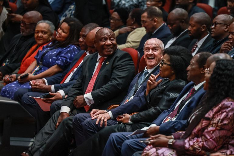 South African President Cyril Ramaphosa (CL) and Former Minister and constitutional negotiator Roelf Meyer (CR) looks at attendees during the first National Convention at the University of South Africa (UNISA) in Pretoria on August 15, 2025.