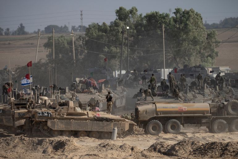 SOUTHERN ISRAEL, ISRAEL - AUGUST 6: Israeli soldiers organize military equipment while standing on armored personnel carriers near the border with the Gaza Strip on August 6, 2025 in Southern Israel, Israel. According to Israeli media reports, senior officials have confirmed Prime Minister Benjamin Netanyahu intends to seek backing from his security cabinet for the