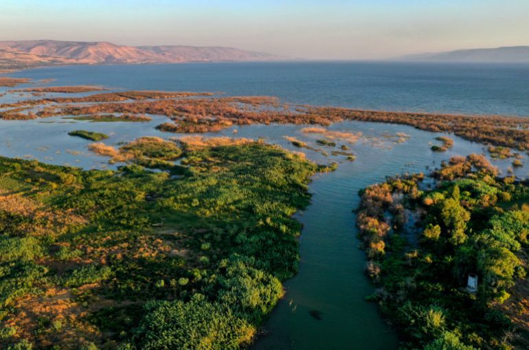 An aerial picture taken on July 11, 2021, shows the Jordan river flowing through the Beteha (Bethsaida Valley) into the northern part of the Sea of Galilee, or Lake Tiberias, one of the main water sources in Israel. As scientific warnings of dire climate change-induced drought grow, many in Israel and Jordan cast worried eyes at the river running between them and the critical but limited resources they share. (Photo by MENAHEM KAHANA / AFP)