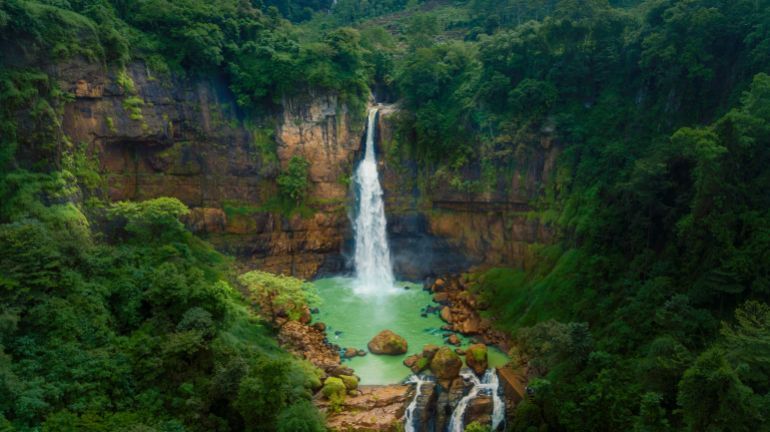 Beautiful scenery of Gitgit waterfall hidden in the tropical forest. Shot in Bali, Indonesia; Shutterstock ID 1169058040; purchase_order: ajnet; job: ; client: ; other: بالي