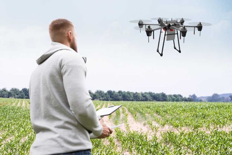 Man Operating The Quadrocopter In The Park